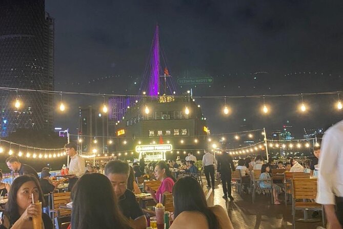 Exploring Ben Thanh Princess Dining Cruise in Ho Chi Minh - Deck Sightlines: Thu Thiem Bridge and Vietcombank Tower at Night